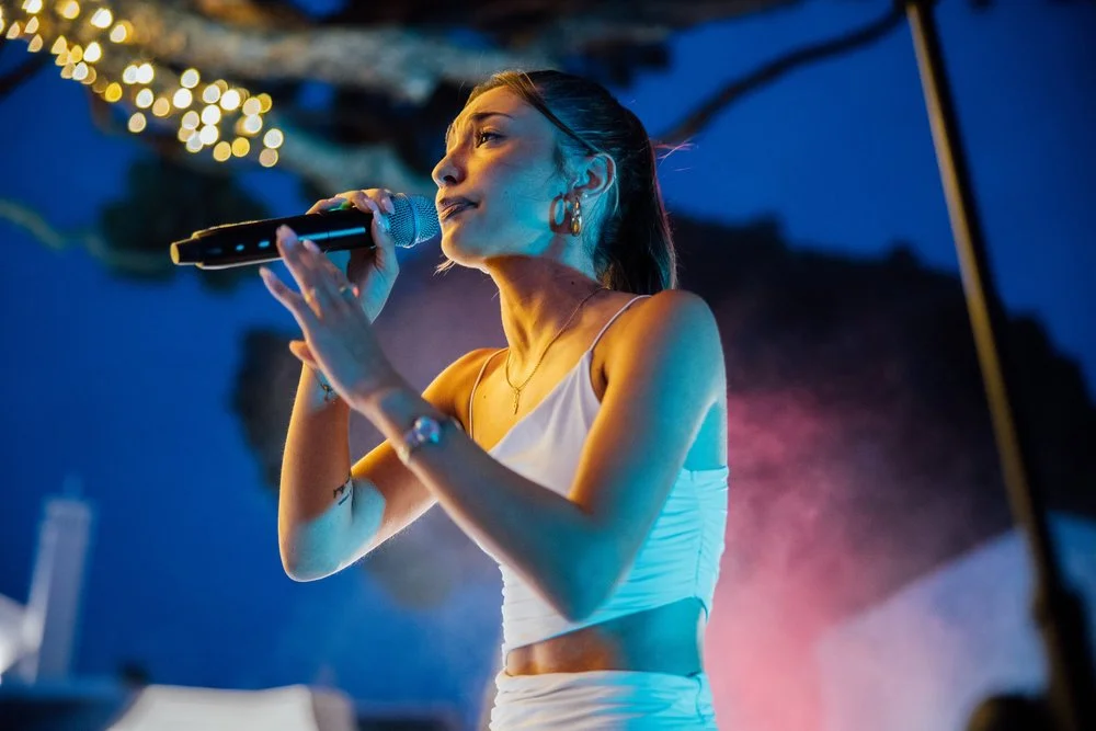Singer performing outdoors at a previous Algarve Music Retreats showcase